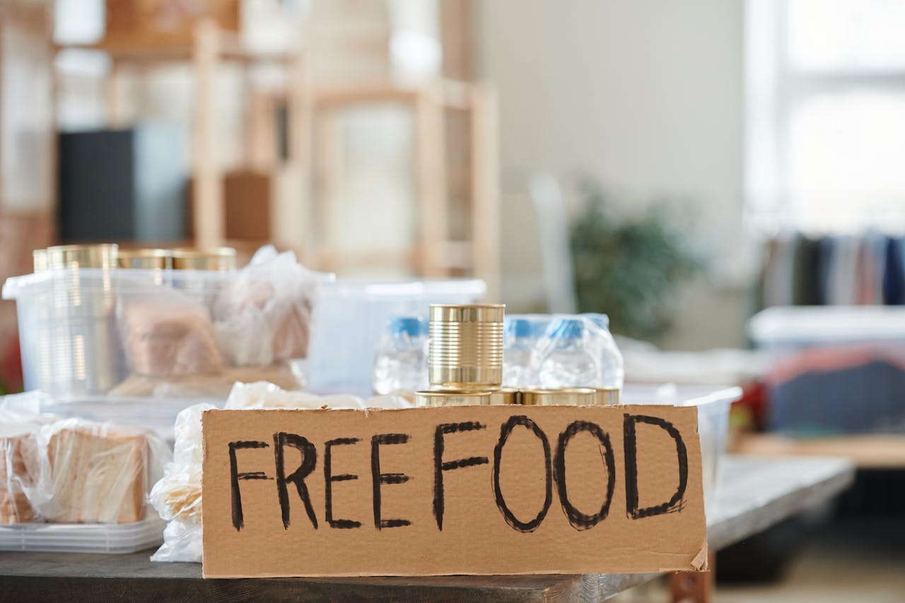 Indoor view of a donation table with free food and canned goods.
